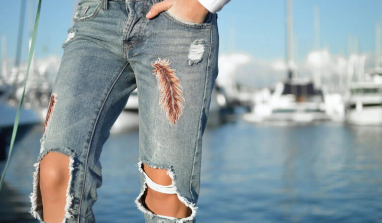 person in gray distressed pants