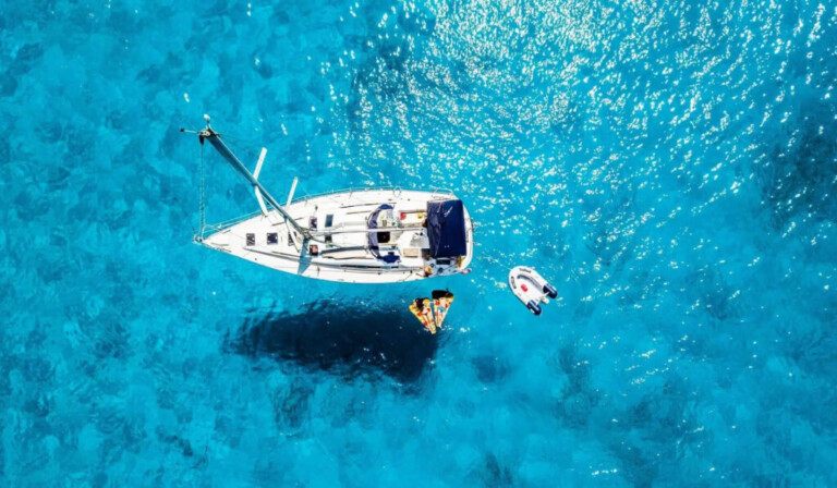 white yacht in middle of blue sea