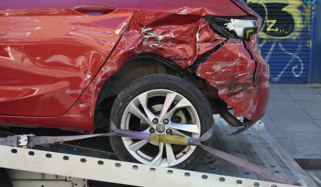 a red car is on a flatbed tow truck