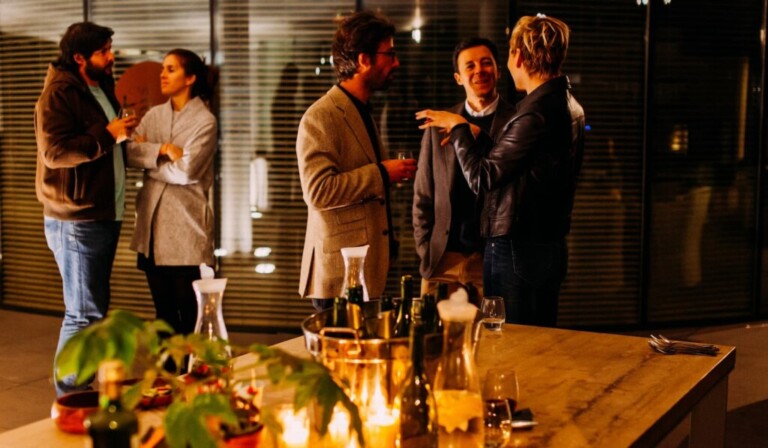 five person standing while talking each other