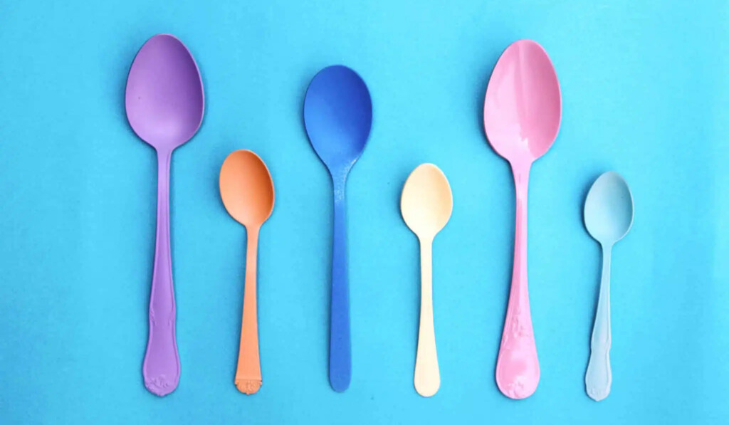 pink plastic spoon on pink and white polka dot textile