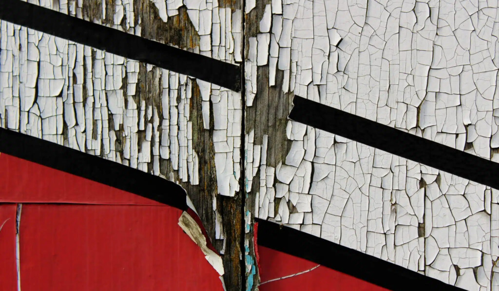 scratched white and red painted wall